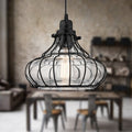 10" Aisling Black Metal Conical pendant light hanging above a dining table with a blurred background