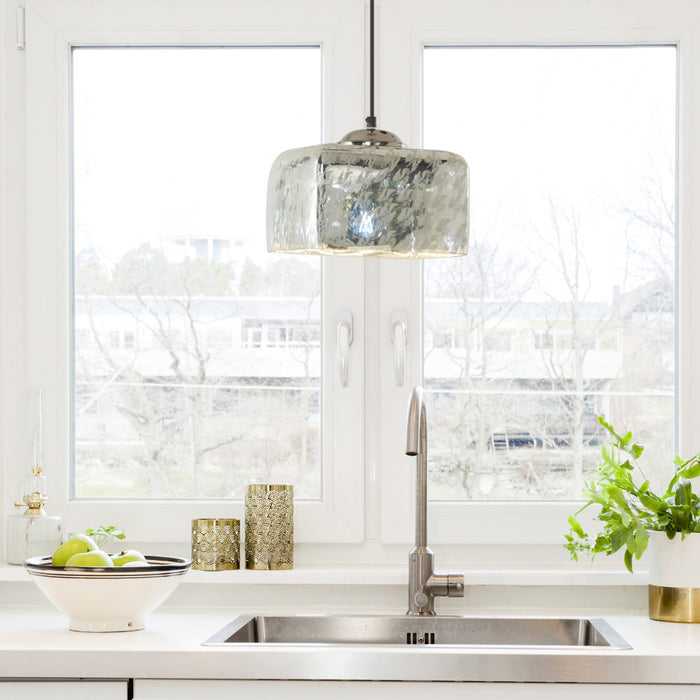 10 in. Nickel 1-Light Pendant with Painted Silver Glass Shade in a modern kitchen with sink and decorative items.