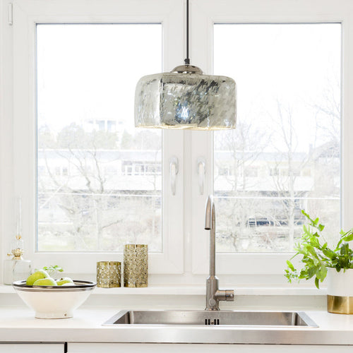 10 in. Nickel 1-Light Pendant with Painted Silver Glass Shade in a modern kitchen with sink and decorative items.