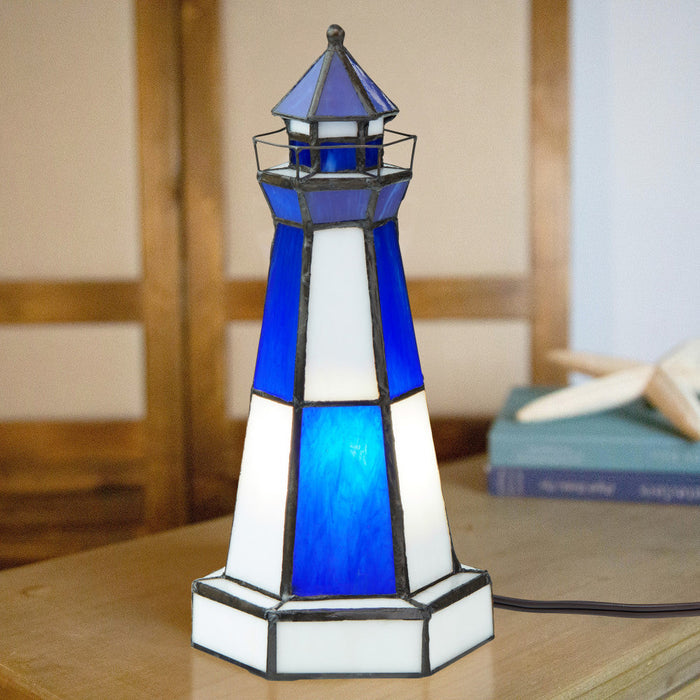 10.4" H Camden Stained Glass Lighthouse Accent Lamp on a wooden surface with a blurred background