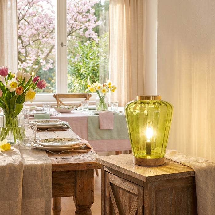 10.5" H Lila Chartreuse Green Glass Shade with a Mango Wood Block Base Accent Lamp in a dining room with a wooden table, and floral arrangements.