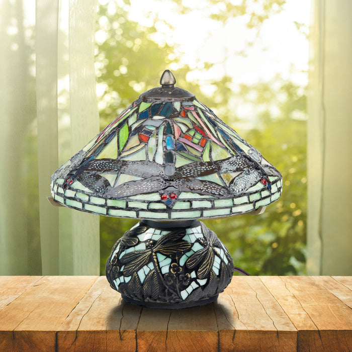 10.5"H Tiffany Style Dragonfly Accent Lamp on a wooden surface in front of window