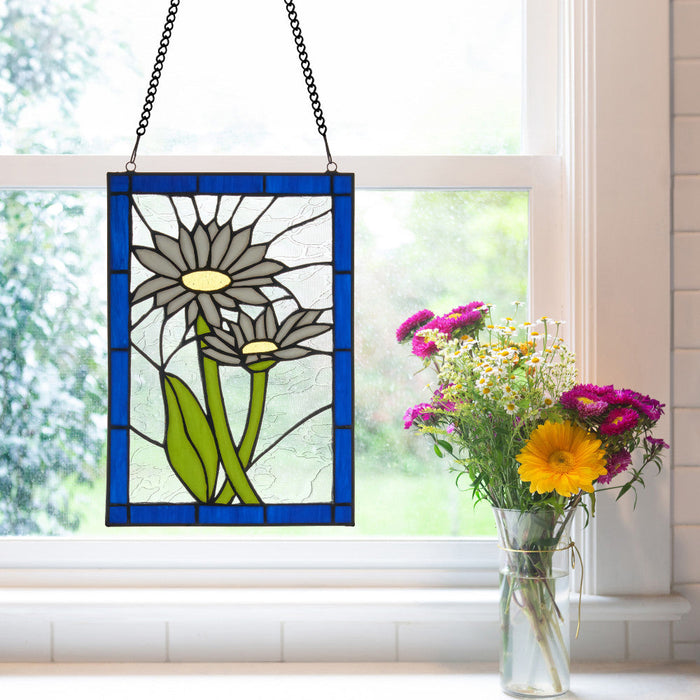 11.25" H Tiffany-Style Daisy Stained Glass Window Panel hanging on a window, next to a vase of flowers.