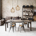 11.75"W Riley Caged Globe Shade Pendant Lighting in a dining area with wooden table, metal chairs, and a brick wall background.