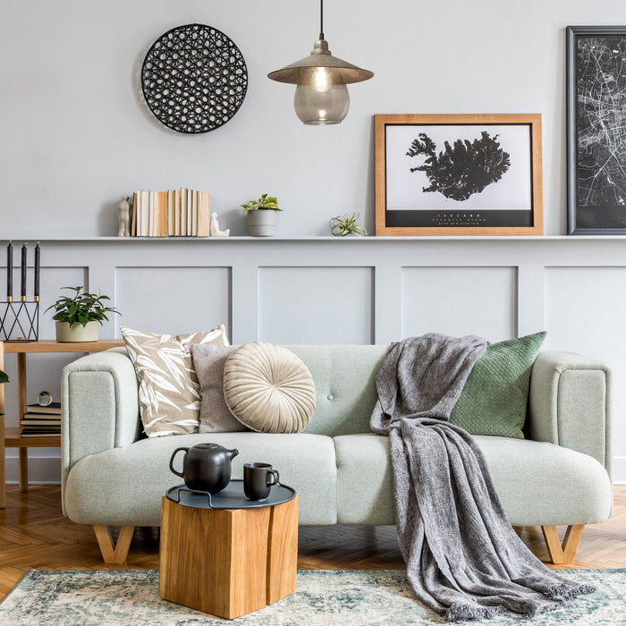 11.8" W 1-Light Charley Glass and Metal Pendant in a cozy living room with a gray sofa, wooden coffee table, and decorative elements.