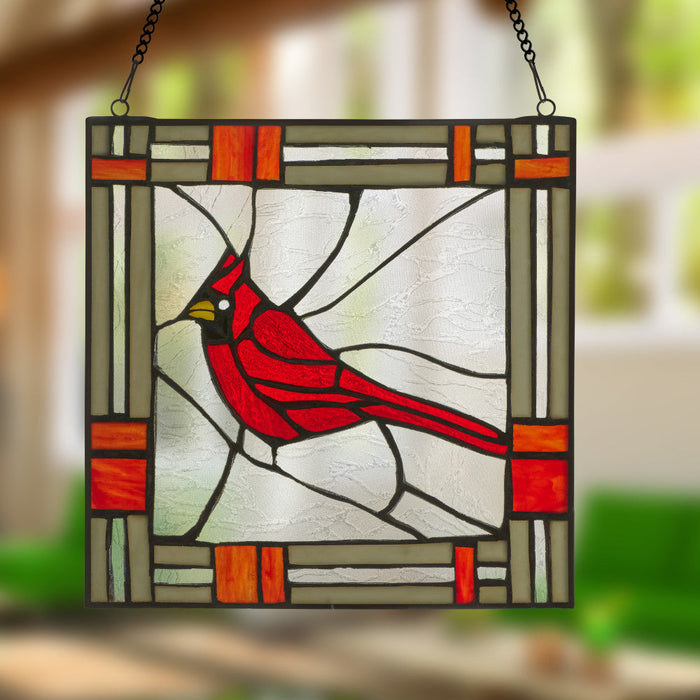 11"H Carol the Cardinal Stained Glass Window Panel hanging against a blurred natural background.