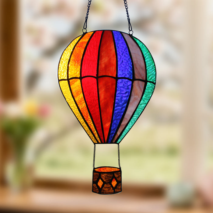 11"H Otis Red Hot Air Balloon Stained Glass Window Panel hanging indoors with a blurred background