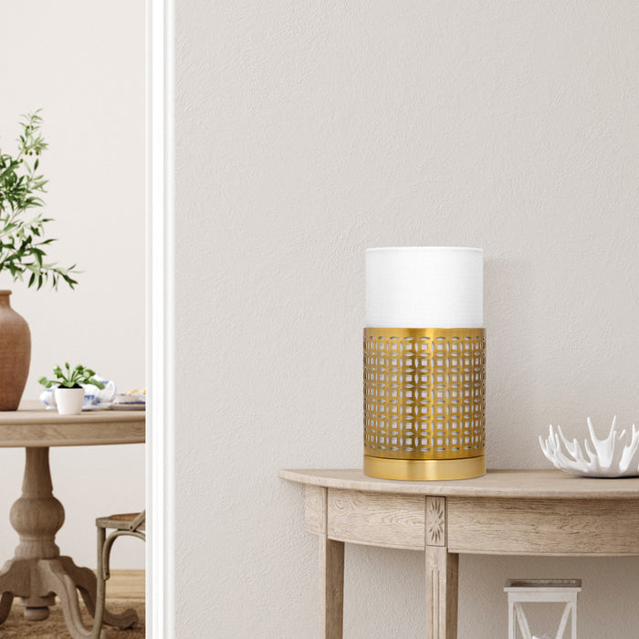 11"H Xander Gold Round Shade Hurricane Lamp on a wooden table.