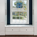 12" H Ilsa Stained Glass Window Panel hanging in a window with white frame and storage drawers.