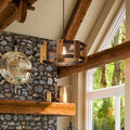 12" W Mattie Black Painted Metal Pendant Light with Wood Shade in a living room with vaulted ceiling, exposed wood and stone fireplace
