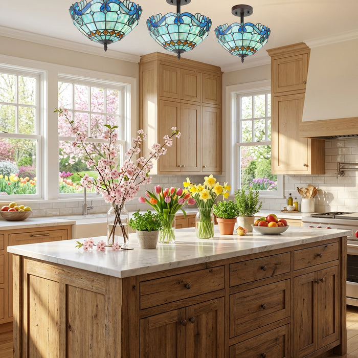 13" H Amelia Blue and Amber Stained Glass Shade Traditional Semi-Flushmount Ceiling Light in a modern kitchen with wooden cabinets, marble island, and decorative flowers.
