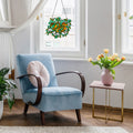 13" W Hanging Plant Tiffany-Style Stained Glass Window Panel hanging in window with a blue armchair with a pink cushion in a bright room with a vase of flowers on a small table.