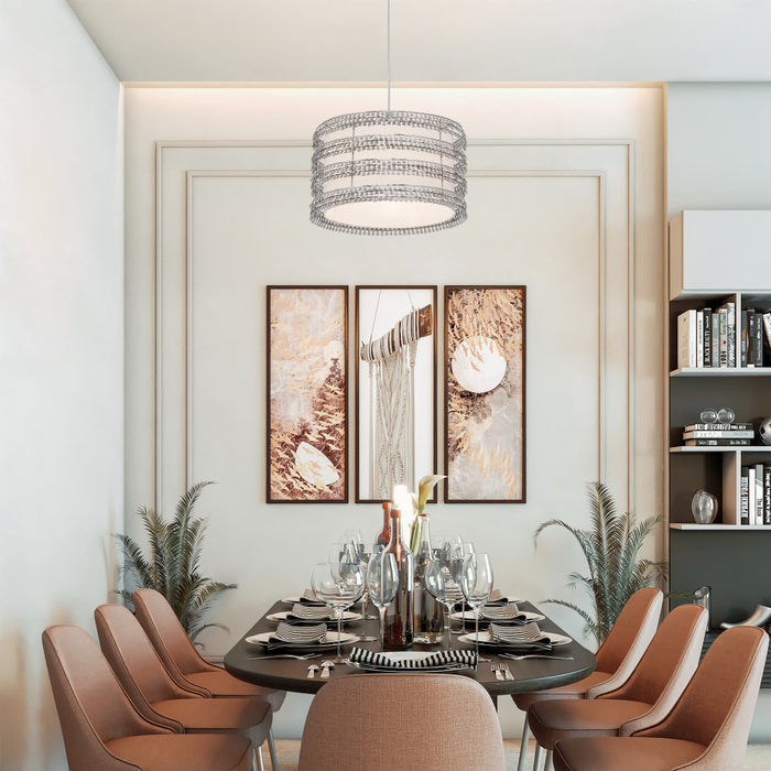 13.375"W Quentin Drum Shade with Charms Pendant Light in a modern dining room with a round table, chairs, and decorative elements.