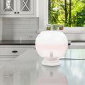 13' H Emily White and Pink Ombre Stacked Base Globe Shade Accent Lamp on a kitchen counter with a window in the background