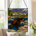 14" H Bear Stained Glass Window Panel hanging with a blurring livingroom in the background