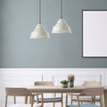 14" W 1-Light Aden Metal Pendant in a modern dining room with wooden table, chairs against a gray wall.