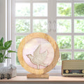 14" W Bird Theme Round Decorative Stained Glass & Metal Stand with Wood Frame in front of a window