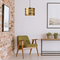 14" W Bruce Gold-Tone Metal Pendant in a modern interior with a green chair, wooden table, and decorative elements.