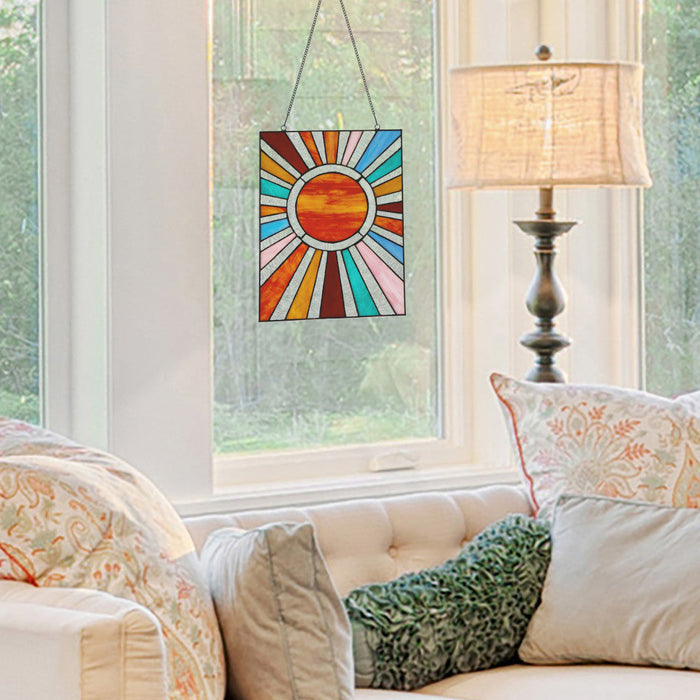 14.5"H Lila Multicolor Sunburst Stained Glass Window Panel hanging in a living room with a lamp and sofa.