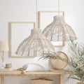 15" 1-Light Elodie Pendant Light Natural Rattan White hanging in a room with a table, plant, and framed pictures.
