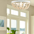 15" Delilah Boho Semi-Flush Mount Ceiling Fixture in a room with large windows and a plant.