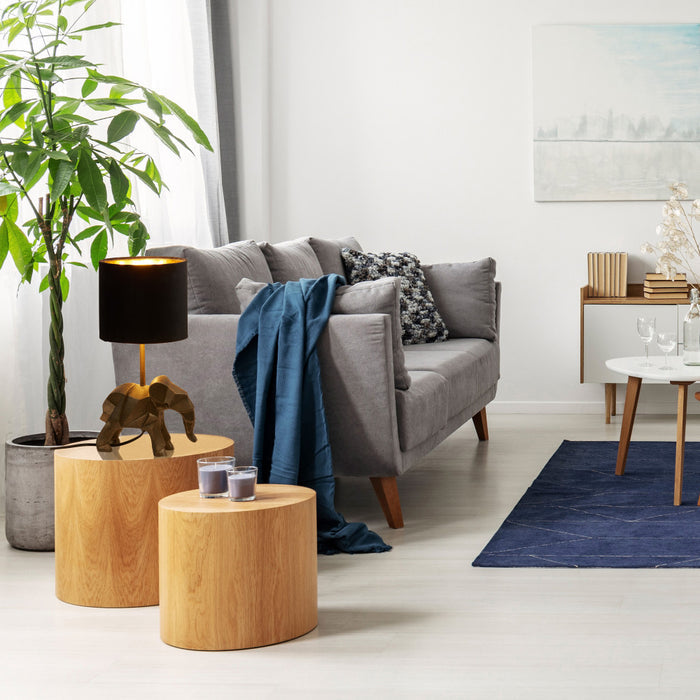15.5'' H Black Drum Shade with Novelty Elephant Base Table Lamp in a modern living room with gray sofa, wooden side tables, and decorative items.