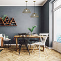 16" W Clara Industrial Gold Dome Shade Pendant in a dining room with wooden table, chairs, and decorative elements against a gray wall.