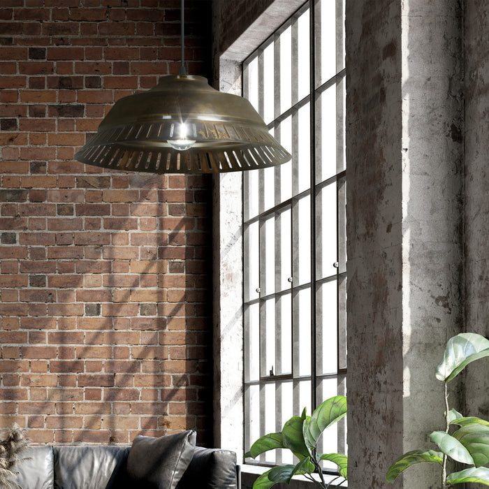 16" W Delano Antique Bronze Metal Pendant Light hanging in a room with brick walls and large windows.