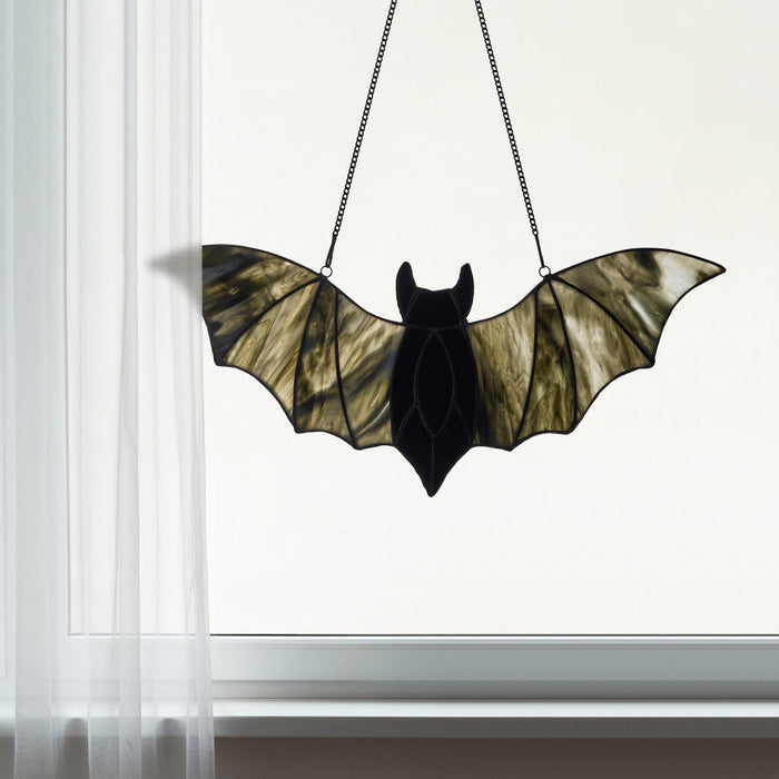 16" W Tiffany-Style Halloween Black Bat Stained Glass Window Panel hanging in a white framed window and shear drapes