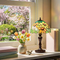 16.5" H Sunflowers Stained Glass Candlestick Table Lamp on a windowsill with flowers and books