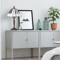 16"H Black and White Stained Glass Piano Keys Table Lamp on a light gray sideboard with decorative items including plants and bottles against a white wall.