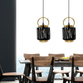 16"H Ford Lantern 1-Light Metal Pendants hanging above a dining table with wooden chairs.