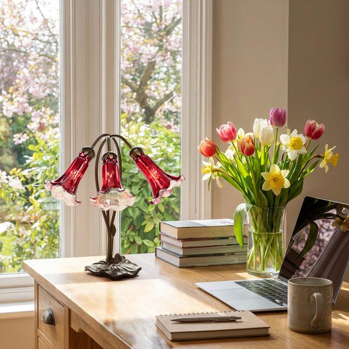 16"H Hand Blown Mercury Glass 3 Lily Downlight Accent Lamp on a home office desk with books, laptop, mug, and flowers by a window.