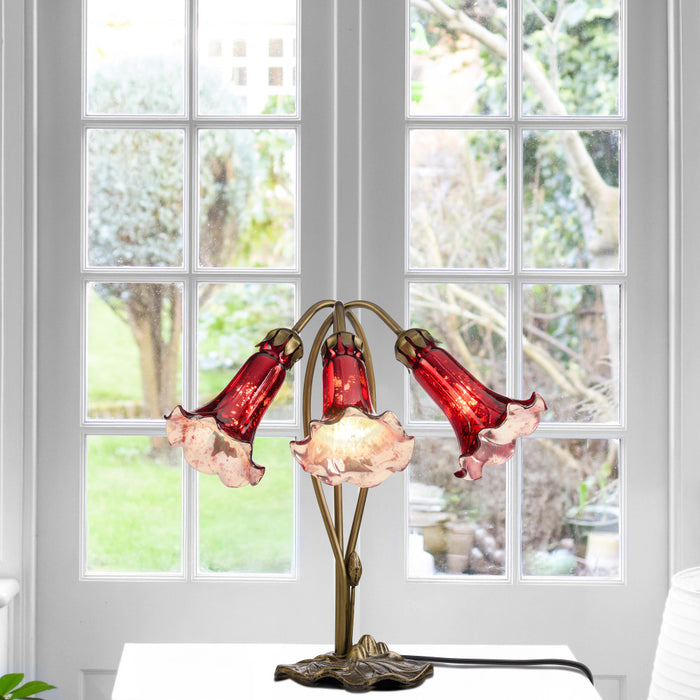 16"H Hand Blown Mercury Glass 3 Lily Downlight Accent Lamp in front of a window