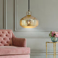 16"H Sorrento Teardrop 1-Light Metal Pendant hanging above a pink sofa in a room with a gold side table and floral arrangement.