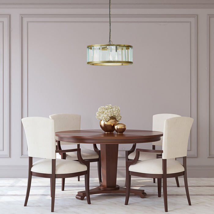 17" W Angelina Gold Metal and Beveled Glass Pendant in a dining room with wooden table and chairs.