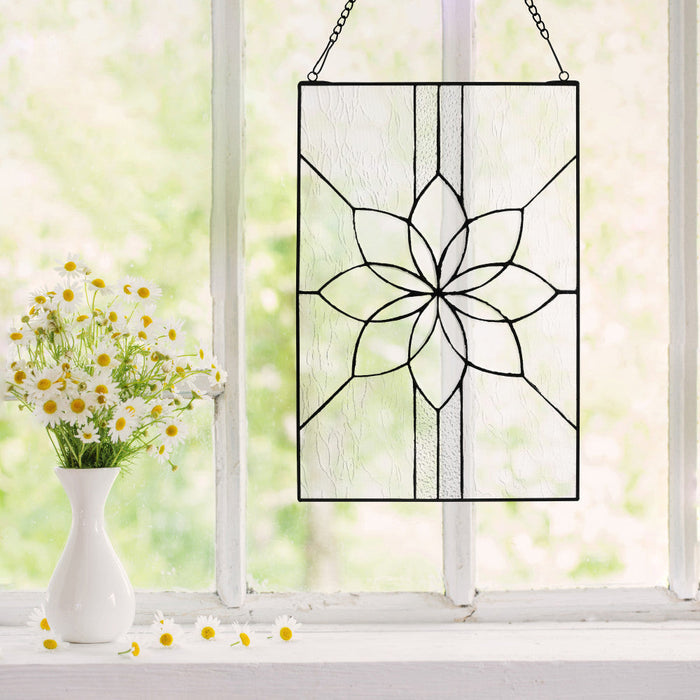 18" H Clear Floral Glass Window Panel hanging in a window with daisies in the foreground.
