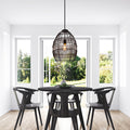 18.5"H Woven Modern Cage Oversized 1-Light Pendant in a modern dining room with black table and chairs.