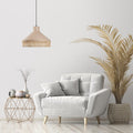 18.5'' W 1-Light Jessica Metal and Cane Transitional Pendant in a modern living room with a gray armchair, side table, and decorative plant.