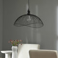 19.75" 1-Light Brigitte Pendant Light Black hanging above a white chair and table against a gray wall.