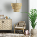 19.75" W 1-Light Antonella Metal and Jute Pendant Light in a living room with, armchair, sideboard, and plant