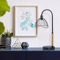 20.5"H Candlestick Base Dome Shade Table Lamp on a blue sideboard with modern interior decor.
