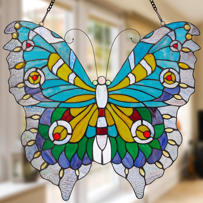 20.5"H Stained Glass Swallowtail Butterfly Window Panel hanging with a blurred background behind