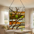 20"H Fall Treescape Stained Glass Window Panel hanging in a room with furniture and decor.