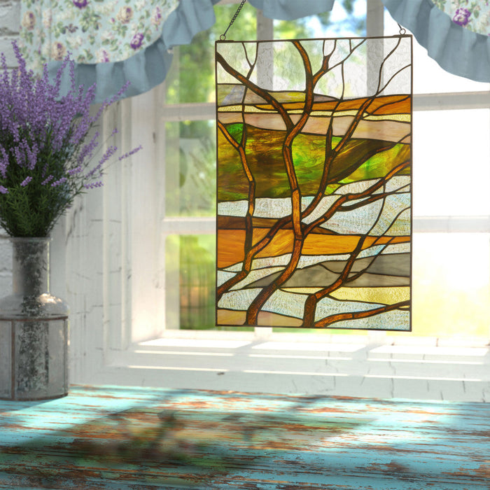 20"H Fall Treescape Stained Glass Window Panel hanging in a window with decorative elements.