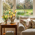 20"H Hand Blown Glass 5 Calla Lily Uplight Accent Lamp in a living room with books and floral arrangement by a window with garden view.