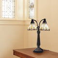 21'' H Bryant Prairie Style Stained Glass Table Lamp with Black Block Base on a wooden surface with stained glass windows in the background.