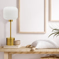 21"H Eagan Globe Shade Table Lamp on a wooden side table against a light wall.