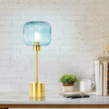 21"H Eagan Globe Shade Table Lamp on a desk against a white brick wall.