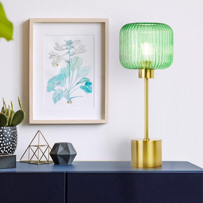 21"H Eagan Globe Shade Table Lamp on a blue sideboard, framed artwork, and decorative items in the background.